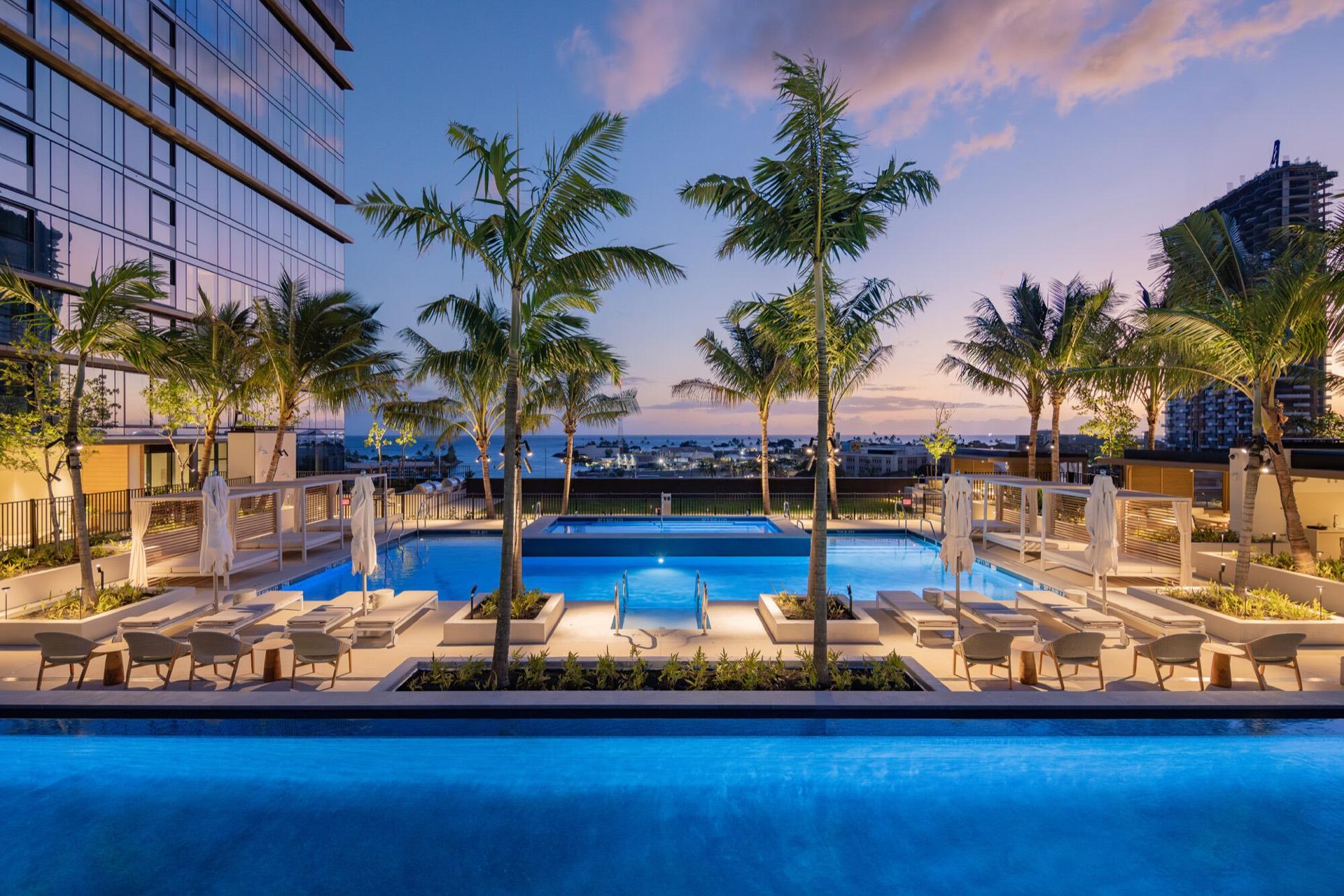 Amenity-deck pools at dusk above Kewalo Harbor